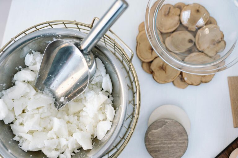 Flatlay of candle wax in a stainless steel bowl with a scooper, perfect for DIY projects.