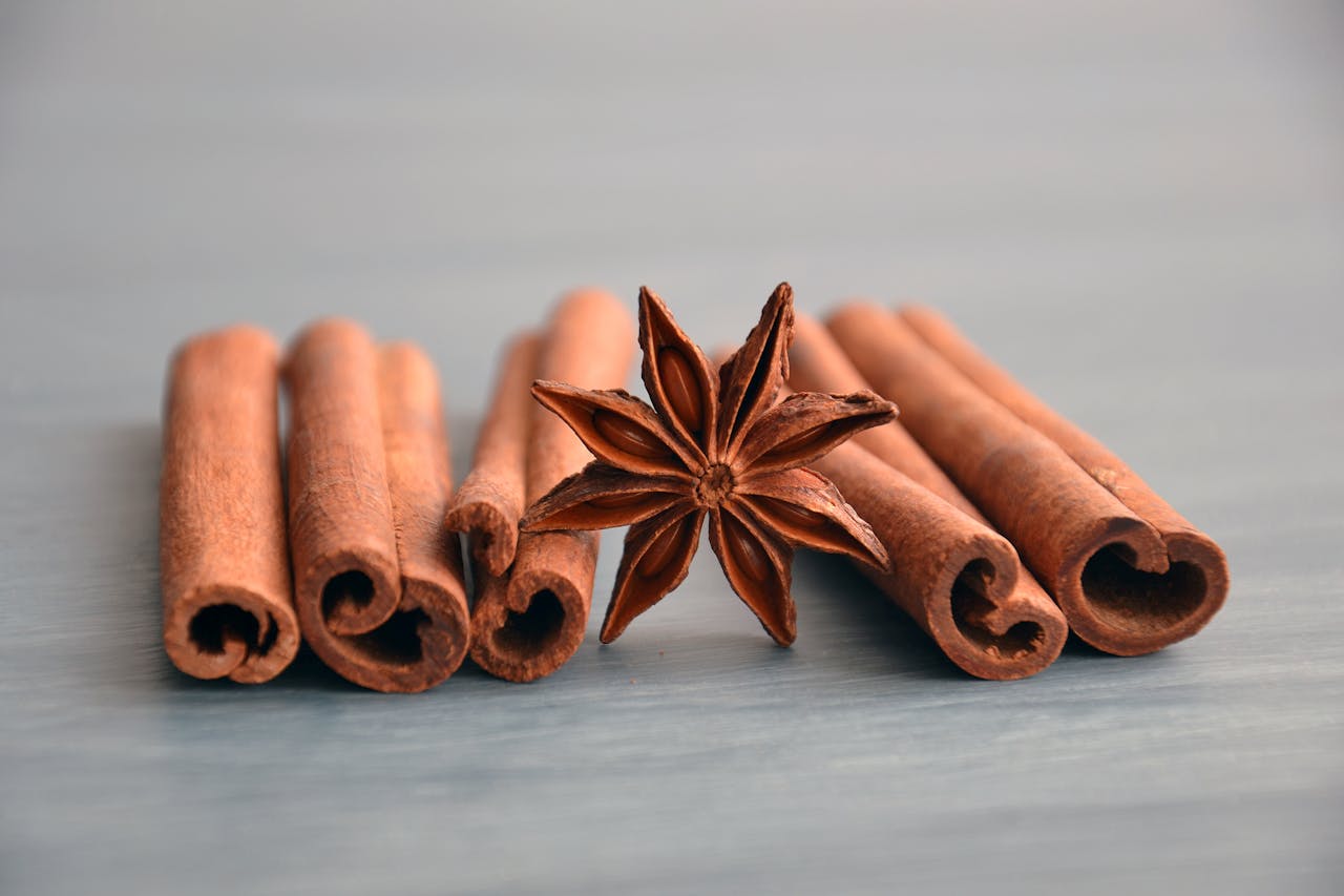 Cinnamon sticks and star anise on a wooden surface, perfect for culinary themes.